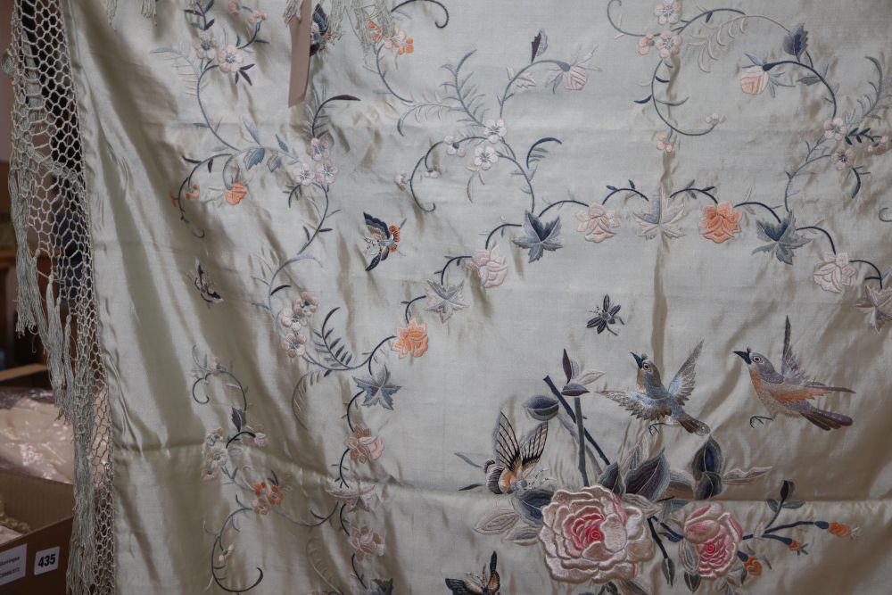 A late 19th century Chinese embroidered and fringed cover, decorated with flowers and butterflies on a pale turquoise background